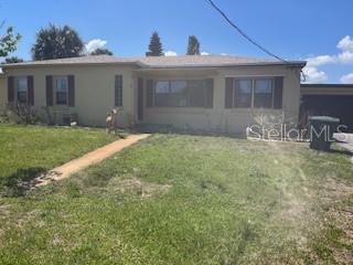 A single-story house with a tan exterior, brown shutters, and a front walkway — 2010 BLAIS AVENUE, DAYTONA BEACH, FL