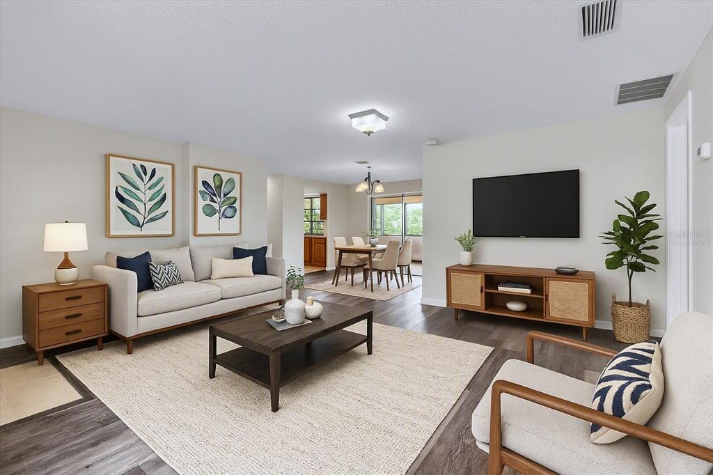 A living room with a beige sofa, wooden coffee table, and television on a media console — 528 MAGNOLIA AVENUE NW, PORT CHARLOTTE, FL