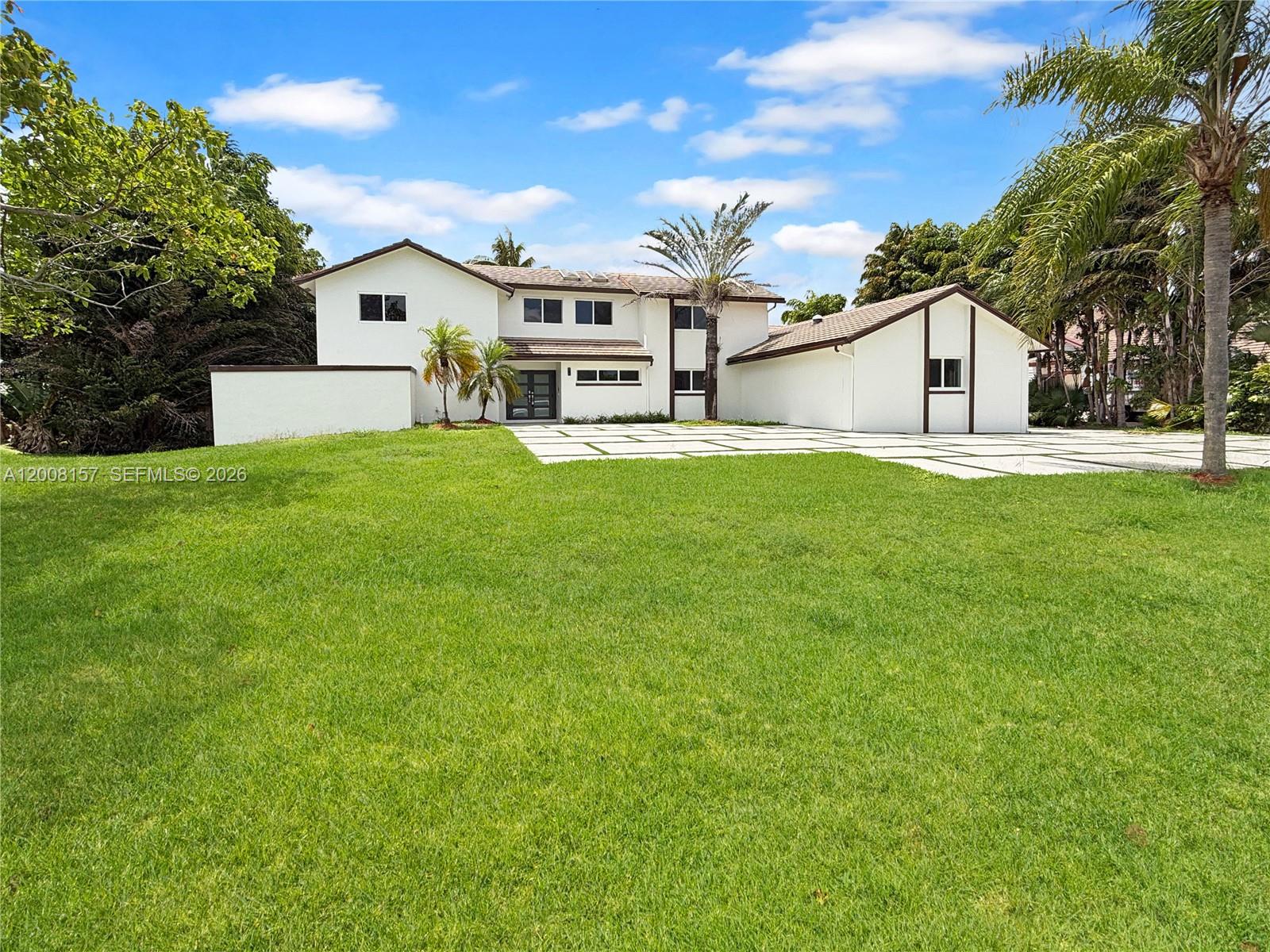 A two-story white house with a large lawn and a paved driveway — 2181 SW 117th Ter, Davie FL 33325, DAVIE, FL