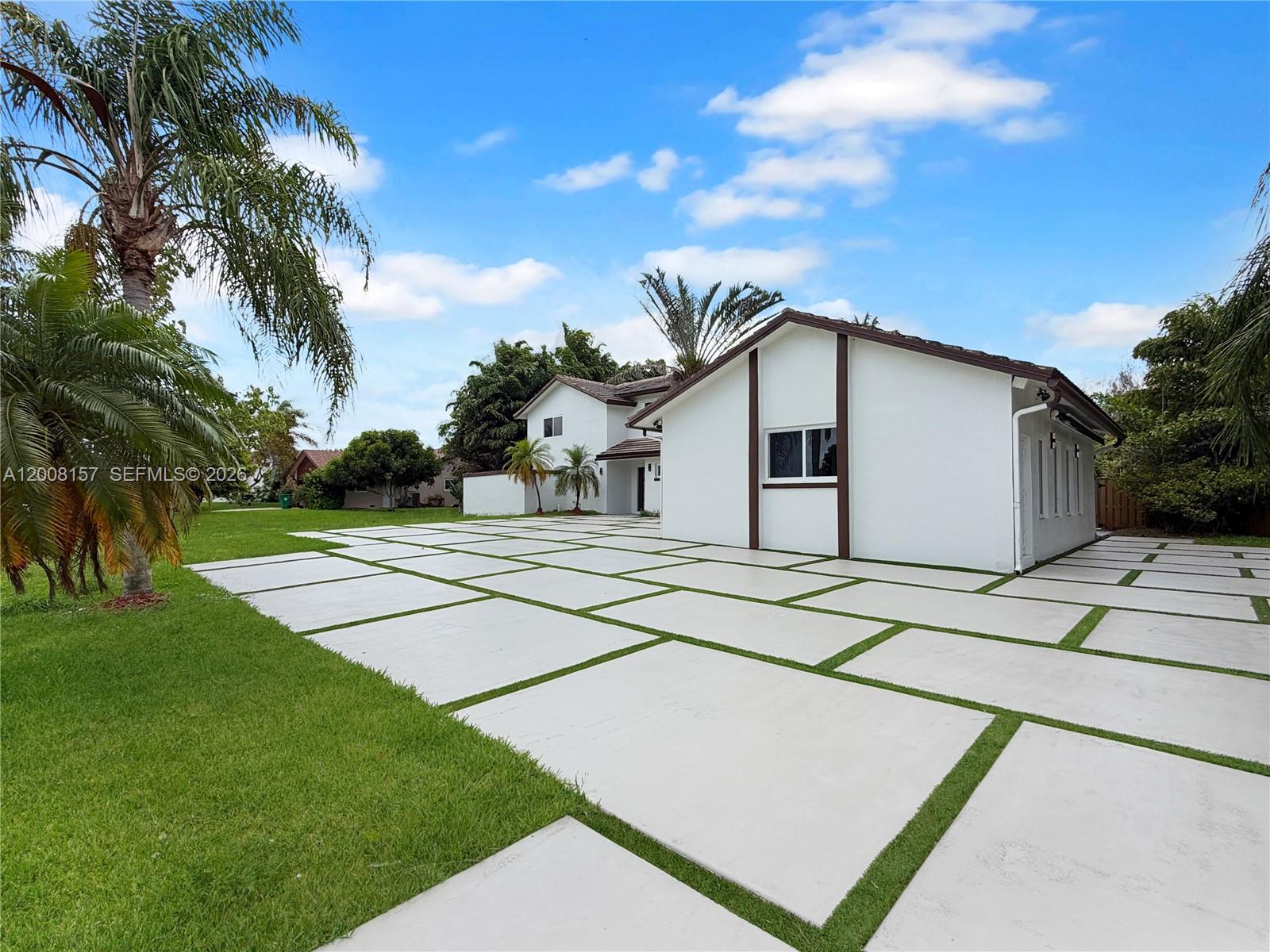 A white house features a large driveway with concrete pavers separated by strips of grass — 2181 SW 117th Ter, Davie FL 33325, DAVIE, FL