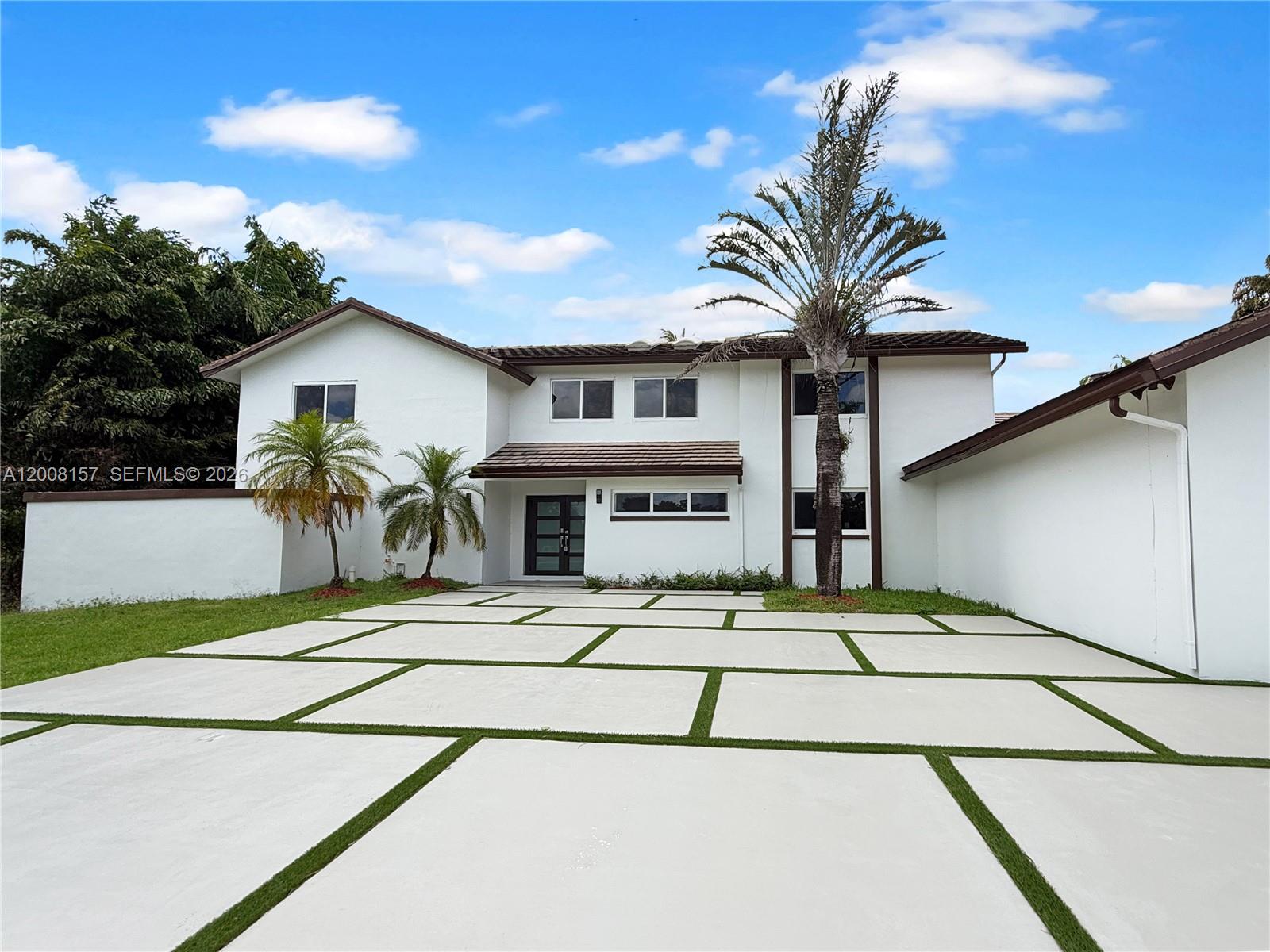 A two-story white house features a modern concrete paver driveway with grass inlays — 2181 SW 117th Ter, Davie FL 33325, DAVIE, FL