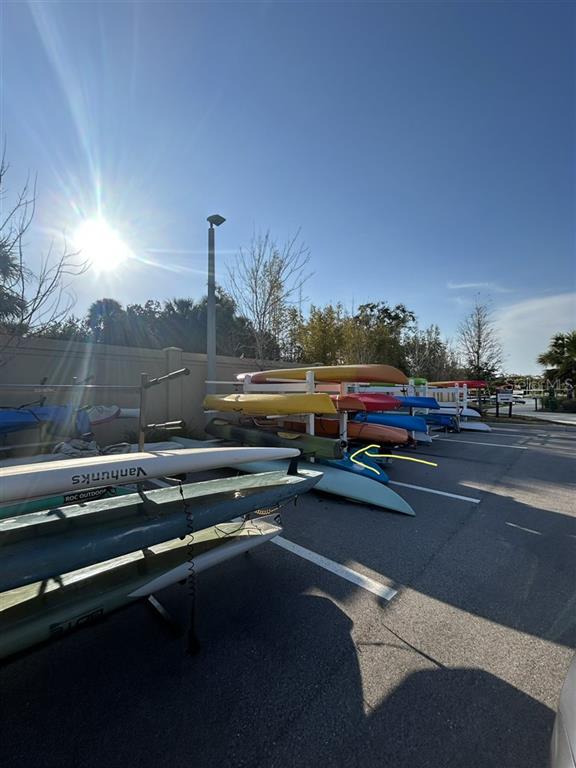 A rack holds several colorful kayaks and paddleboards in an outdoor parking area — 1703 N TAMIAMI TRAIL UNIT 510, SARASOTA, FL