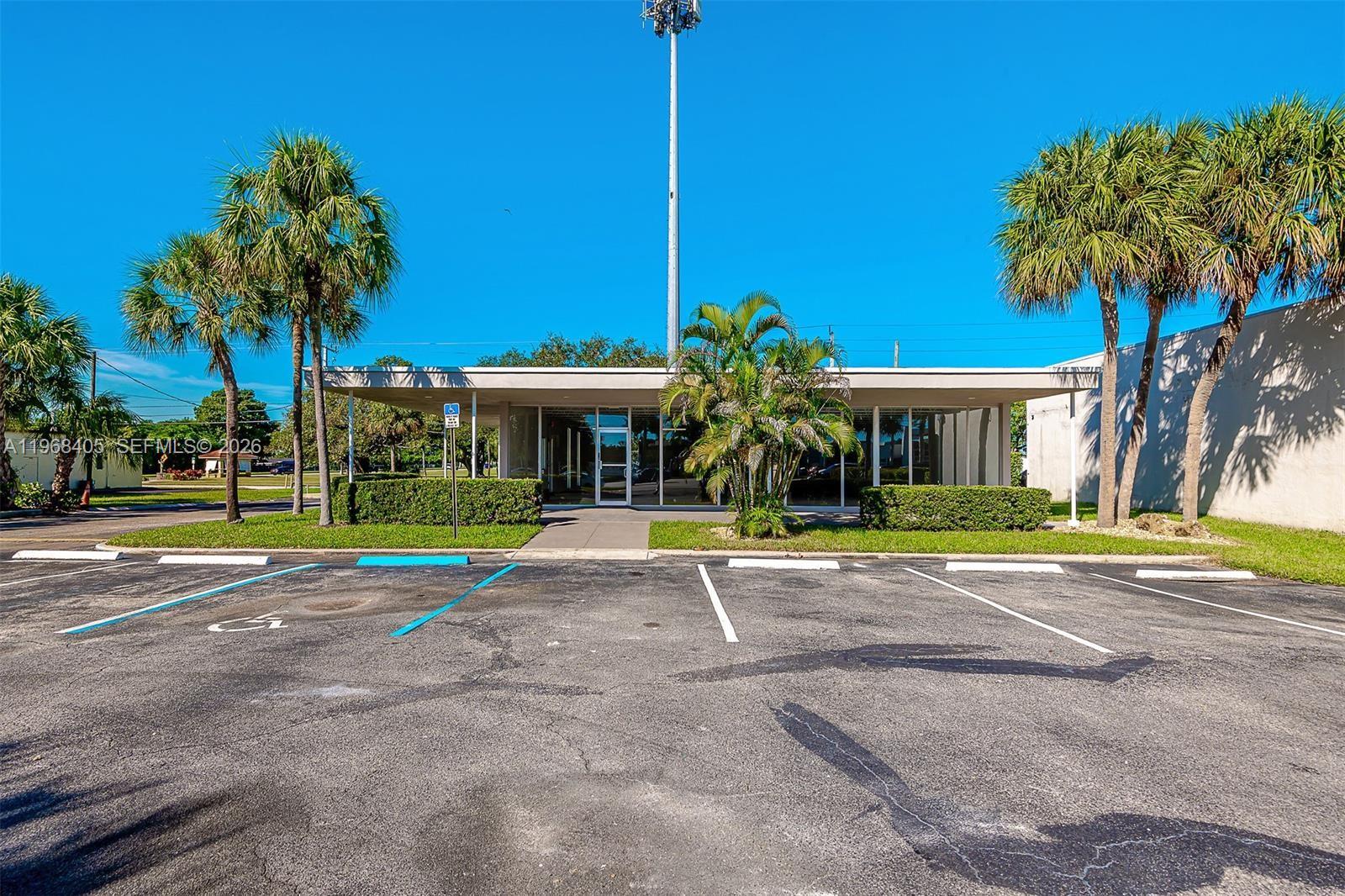A single-story commercial building with a flat roof and glass facade sits behind a parking lot — 2121 N State Road 7, Margate FL 33063, MARGATE, FL