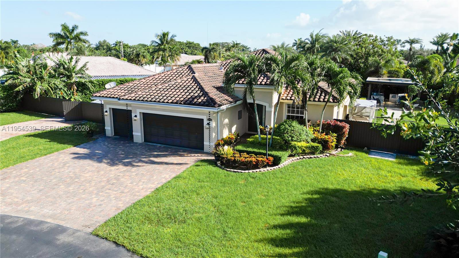 An aerial view shows a single-story house with a tile roof, garage, and landscaped yard — 2133 NW 14th Pl, Homestead FL 33030, HOMESTEAD, FL