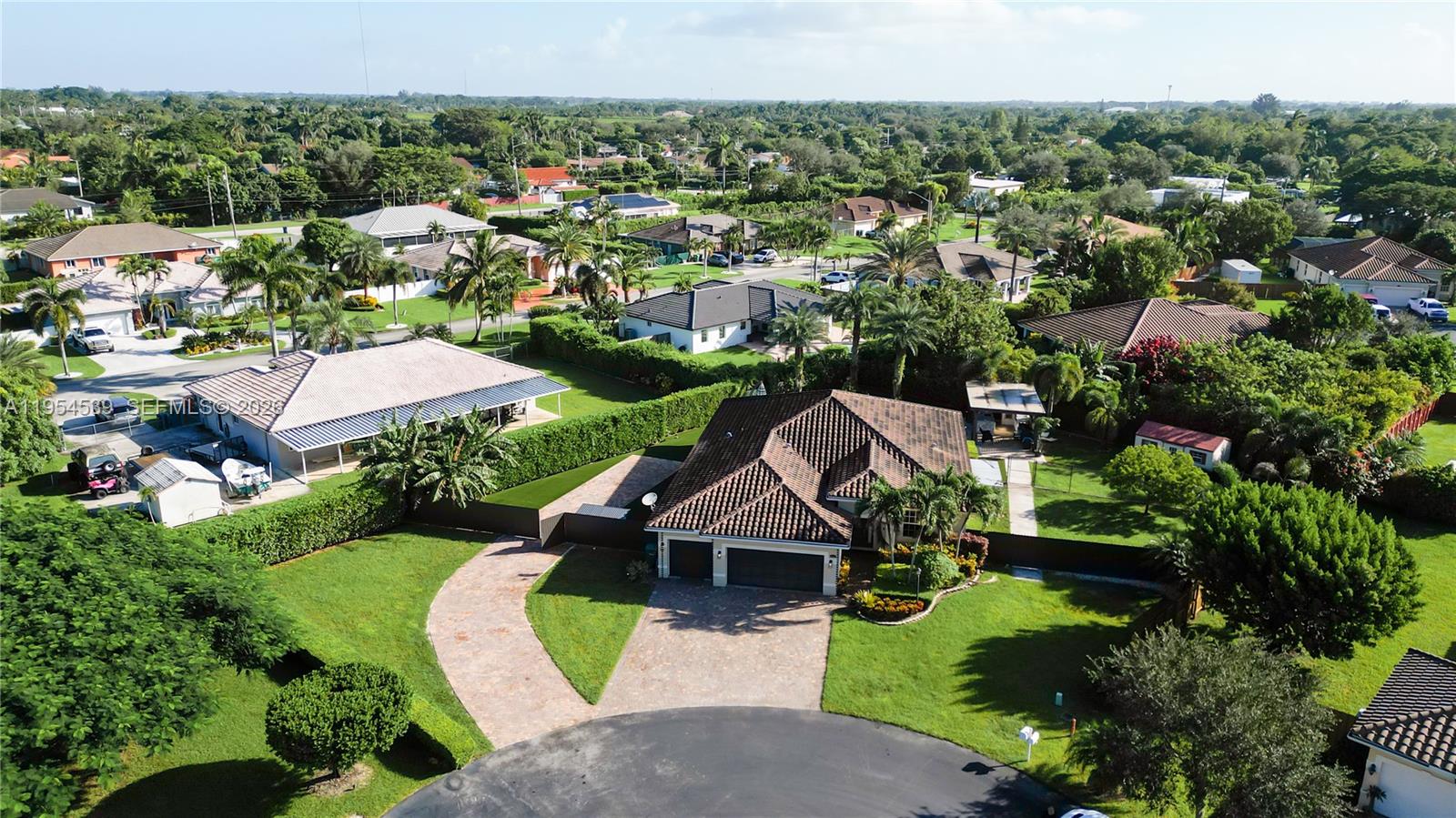 An aerial view shows a suburban house with a tiled roof and a paved driveway — 2133 NW 14th Pl, Homestead FL 33030, HOMESTEAD, FL