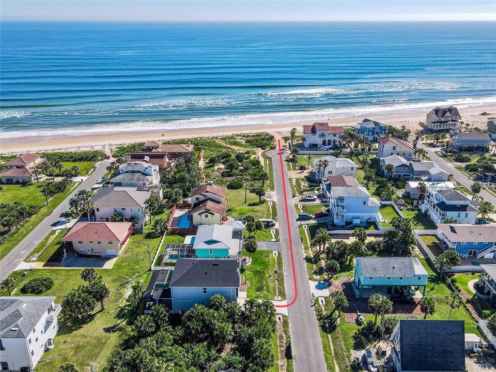 Aerial view of a coastal neighborhood with a red line indicating a street access path — 55 ATLANTIC DRIVE, PALM COAST, FL