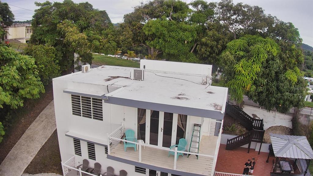 An aerial view of a two-story white house with a flat roof and a balcony — Carr. 115 SECTOR SOTO ROAD, RINCON, PR