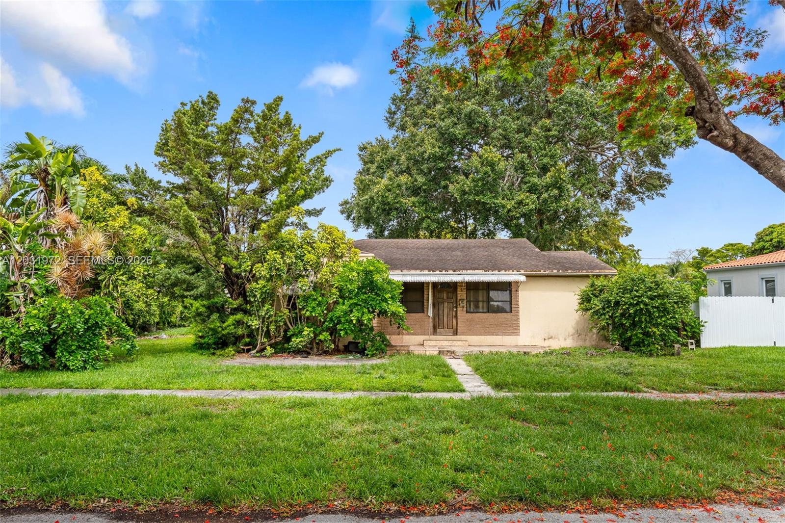 A single-story house with a brown roof and tan exterior sits behind a grassy yard — 3900 SW 59th Ave, Miami FL 33155, MIAMI, FL
