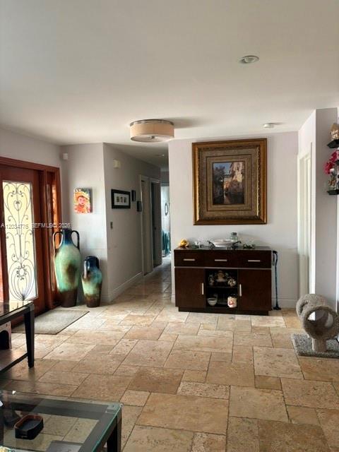 A tiled entryway features a wooden sideboard, a large framed painting, and decorative vases — 9624 SW 79th Ter, Miami FL 33173, MIAMI, FL