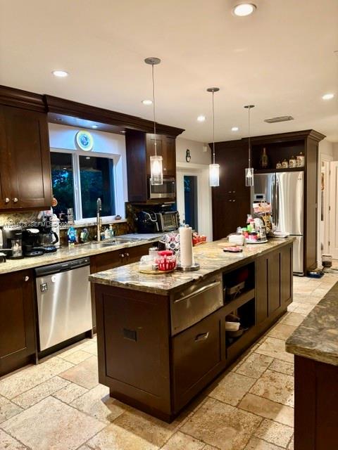 A kitchen features dark wood cabinetry, a large granite-topped island, and stone tile flooring — 9624 SW 79th Ter, Miami FL 33173, MIAMI, FL
