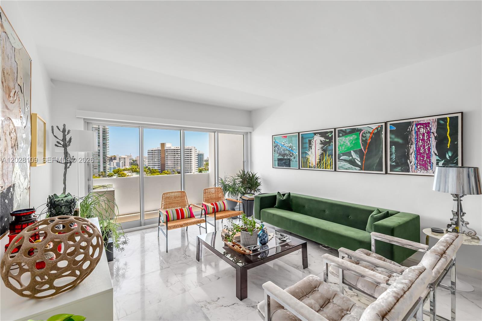 A living room features a green sofa, marble floors, and a balcony with city views — 3 Island Ave # 11B, Miami Beach FL 33139, MIAMI BEACH, FL