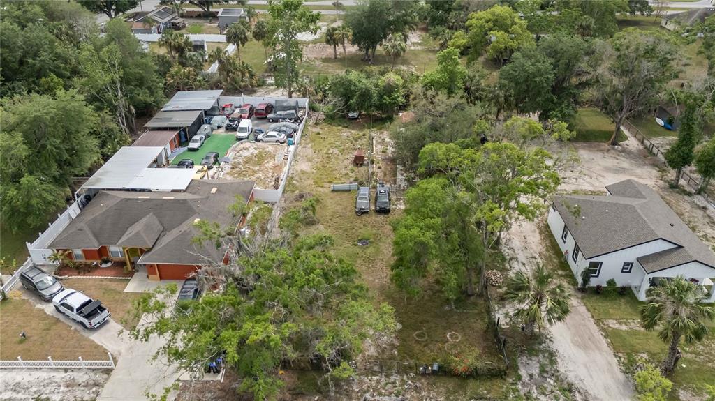 An aerial view shows two houses separated by a large, partially wooded vacant lot — 0 3RD AVENUE, ORLANDO, FL