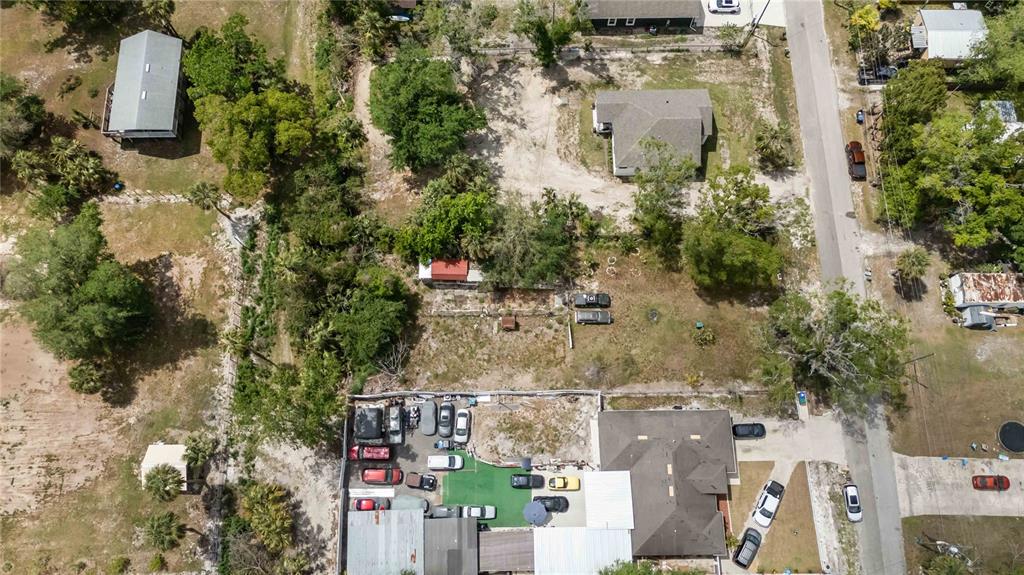 An aerial view shows a residential property with a house, outbuildings, and several parked vehicles — 0 3RD AVENUE, ORLANDO, FL
