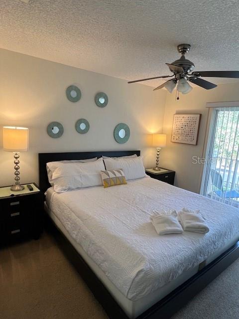 A bedroom features a queen bed, two nightstands with lamps, and circular wall mirrors — 8405 CRYSTAL COVE LOOP, KISSIMMEE, FL