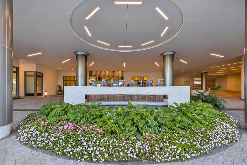A circular garden with pink flowers sits before a covered entrance marked with Saltaire signage — 301 1ST STREET S UNIT 3205, ST PETERSBURG, FL