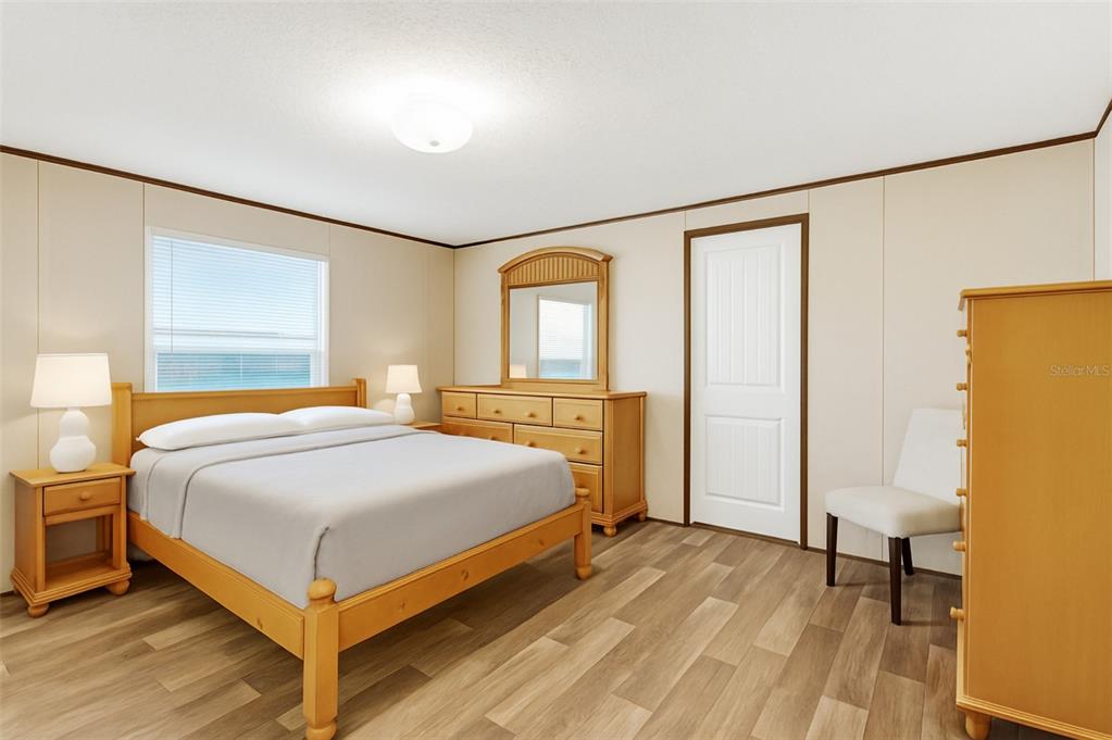 A bedroom features a wooden bed frame, matching dresser with mirror, and light-colored wood flooring — 327 TINDEL CAMP ROAD, LAKE WALES, FL