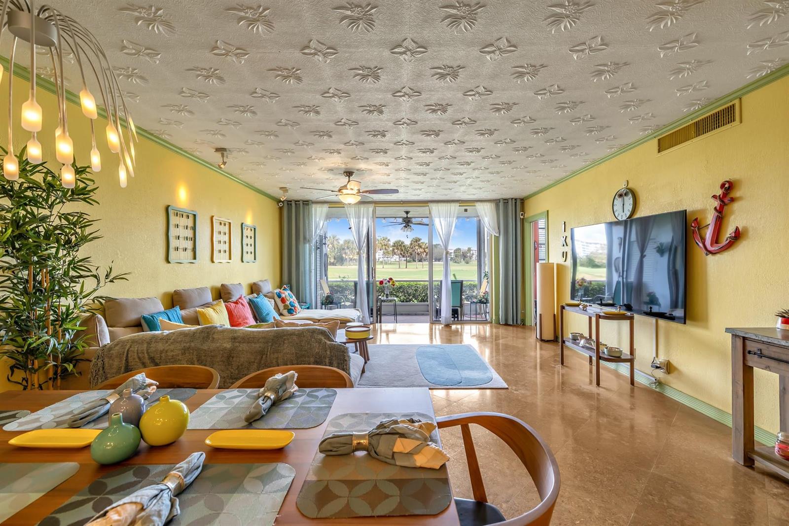 A living and dining room with yellow walls, a patterned ceiling, and a golf course view — 3001 S Palm Aire Drive # 105, Pompano Beach FL 33069, POMPANO BEACH, FL