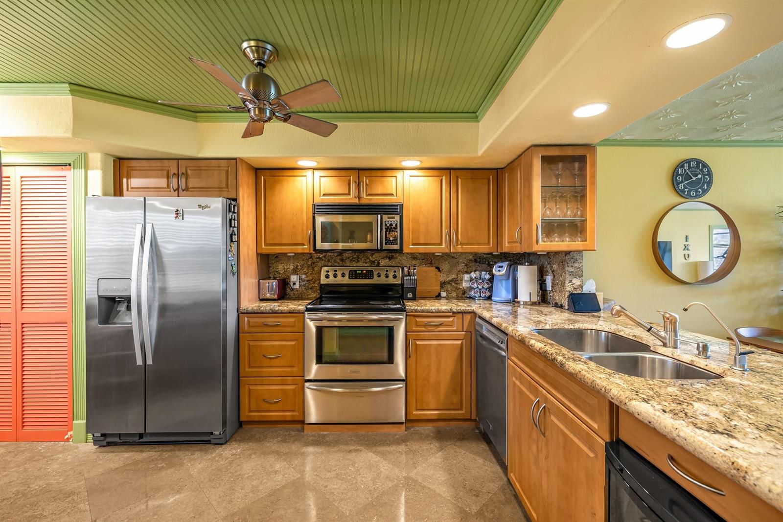A kitchen features wood cabinets, stainless steel appliances, granite countertops, and a green ceiling — 3001 S Palm Aire Drive # 105, Pompano Beach FL 33069, POMPANO BEACH, FL