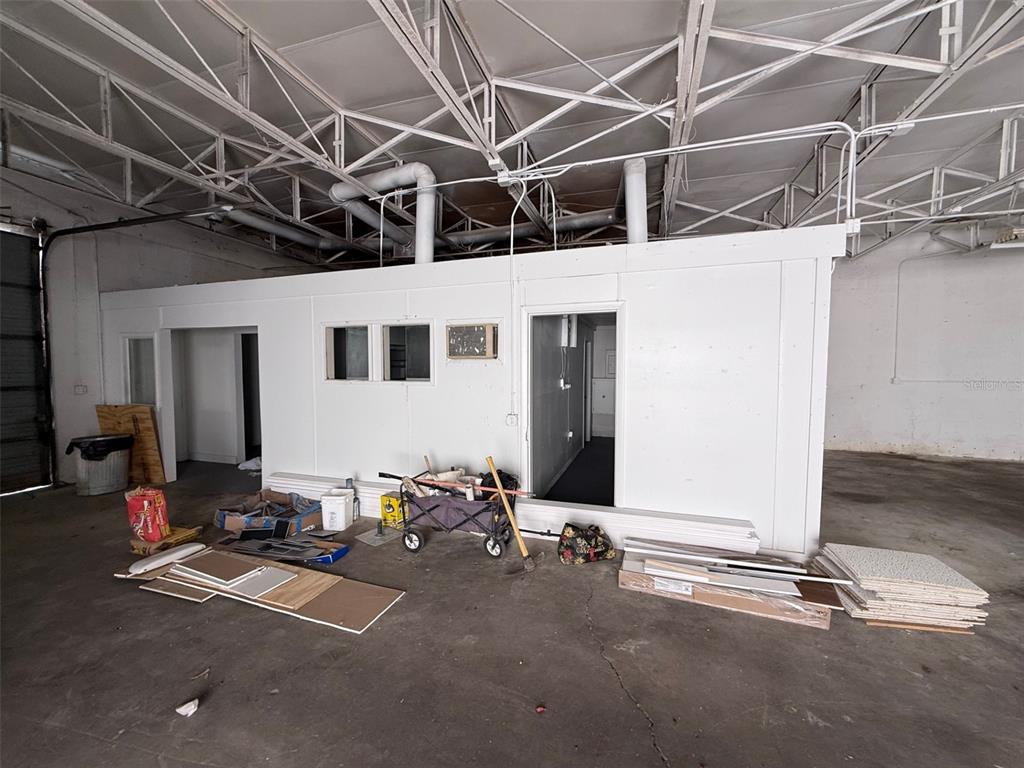 A freestanding modular office structure sits inside a large, unfinished industrial warehouse space — 14020 NW 19TH AVENUE, OPA LOCKA, FL