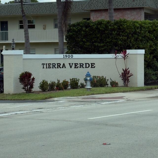 A beige stucco monument sign for Tierra Verde stands in front of a residential building — 1900 S Kanner Hwy Highway Apt 102, Stuart FL 34994, STUART, FL