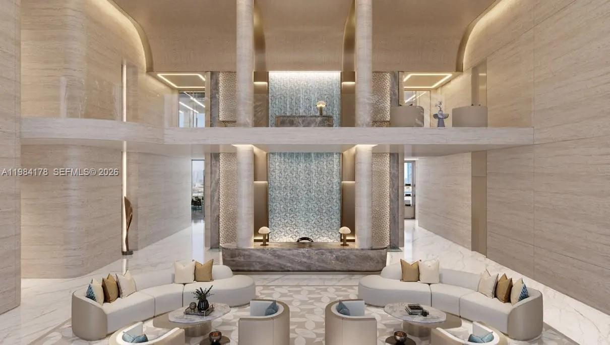 This rendering shows a luxurious, double-height lobby with marble walls, a central water feature, and seating — 55 Al Wasl Road, Dubai, FL