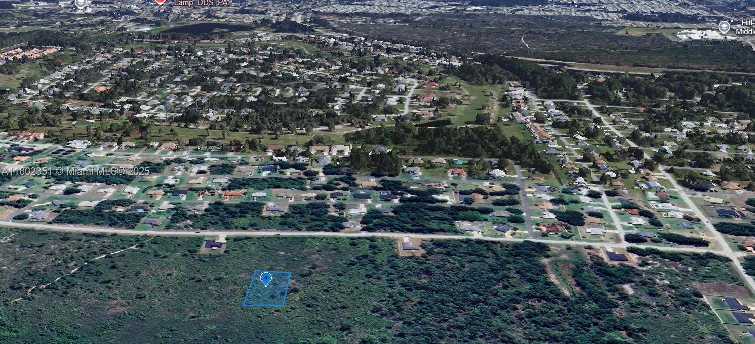 An aerial view shows a vacant rectangular plot of land situated near a residential neighborhood — 4601 MAJORCA, Sebring FL 33872, SEBRING, FL