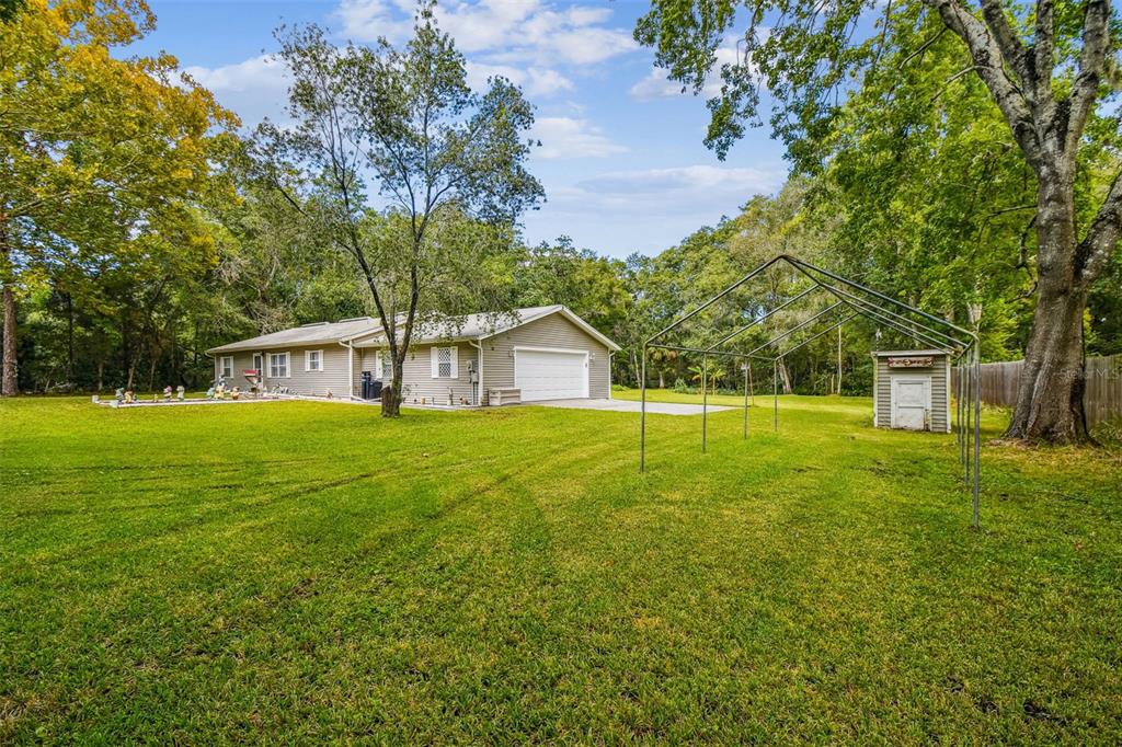 An aerial view shows two houses on a large, wooded lot with a shared driveway — 9741 STAR TRAIL, NEW PORT RICHEY, FL