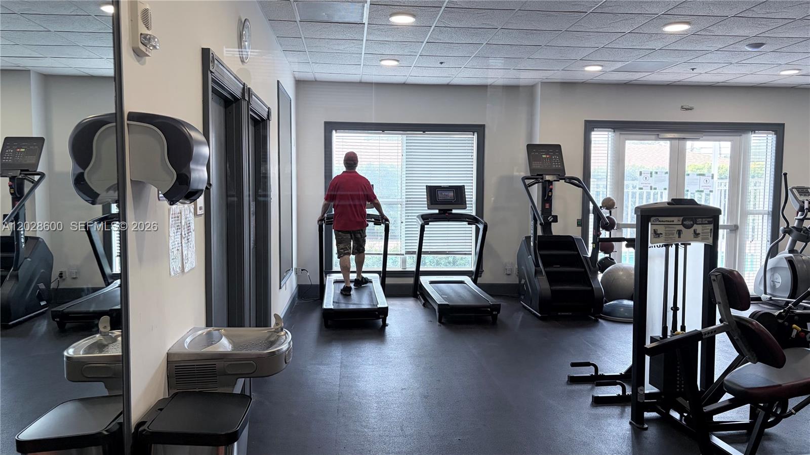 A gym room features several treadmills, a stair climber, a weight machine, and a water fountain — 2665 SW 37th Ave # 405, Miami FL 33133, MIAMI, FL