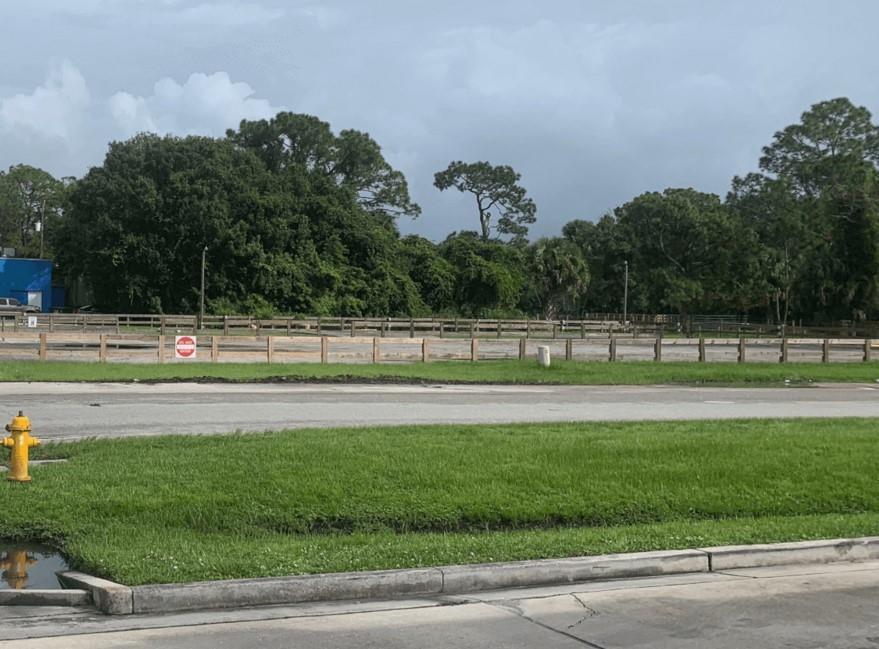 A vacant, fenced-in dirt lot sits behind a grassy lawn and a fire hydrant — 1600 State Road 70, Okeechobee FL 34972, OKEECHOBEE, FL