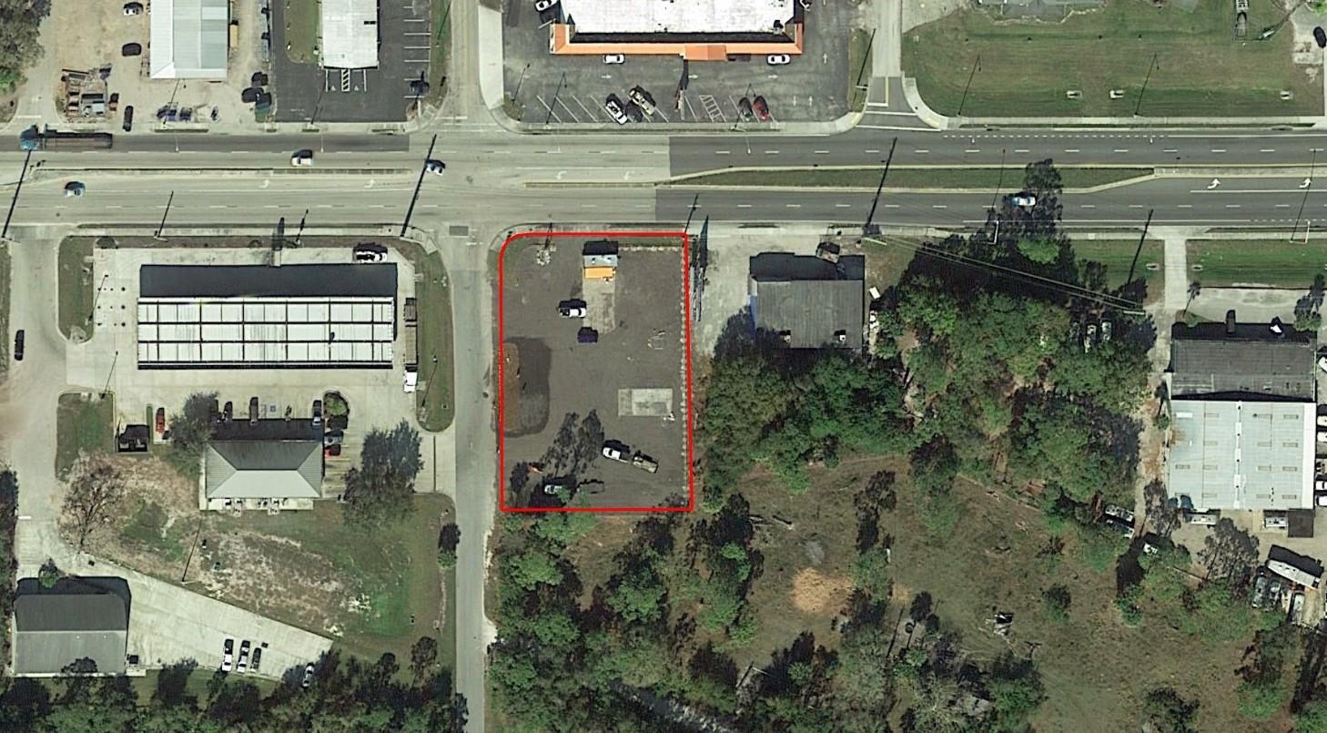 An aerial view shows a vacant, rectangular lot outlined in red at a street intersection — 1600 State Road 70, Okeechobee FL 34972, OKEECHOBEE, FL