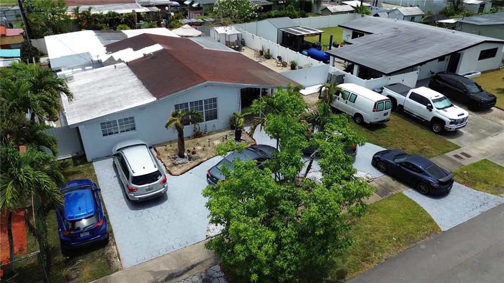 An aerial view shows a house with a driveway containing several parked vehicles — 18615 SW 98TH AVENUE, MIAMI, FL