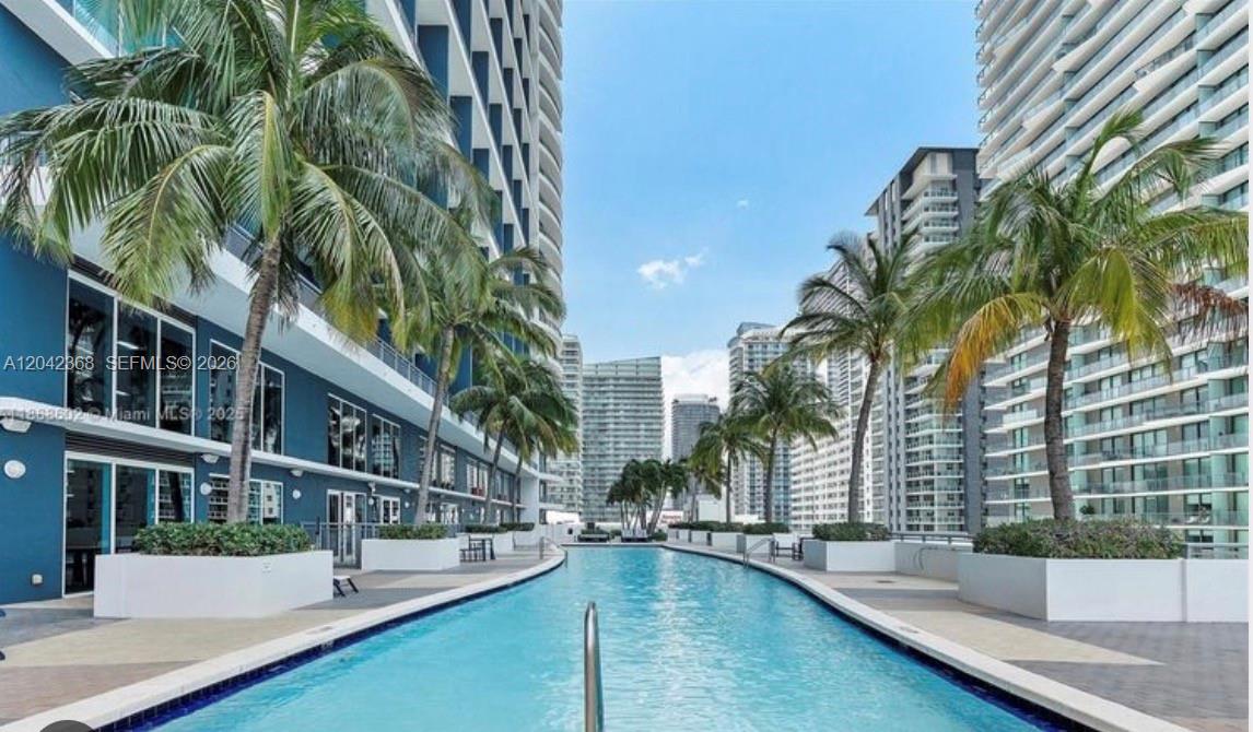 A long, narrow swimming pool is situated between two modern high-rise apartment buildings — 60 SW 13th St # 1621, Miami FL 33130, MIAMI, FL