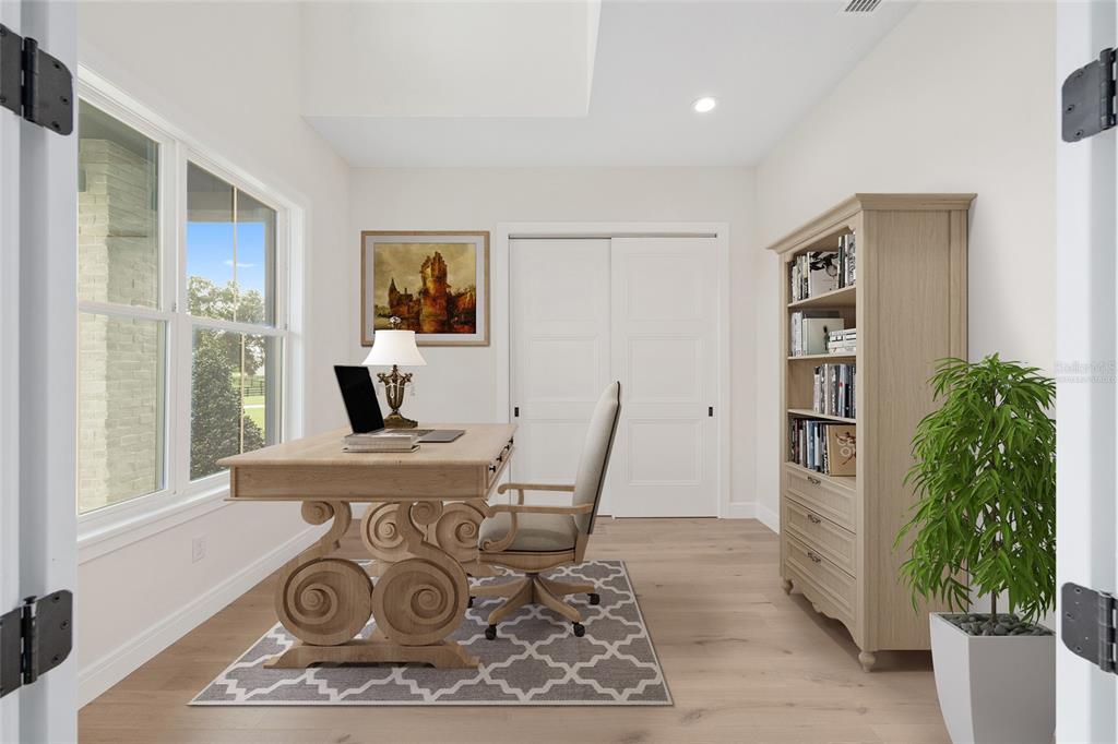 This is a digital rendering of a home office featuring a desk, chair, and bookshelf — 11324 NW 50 LANE, OCALA, FL