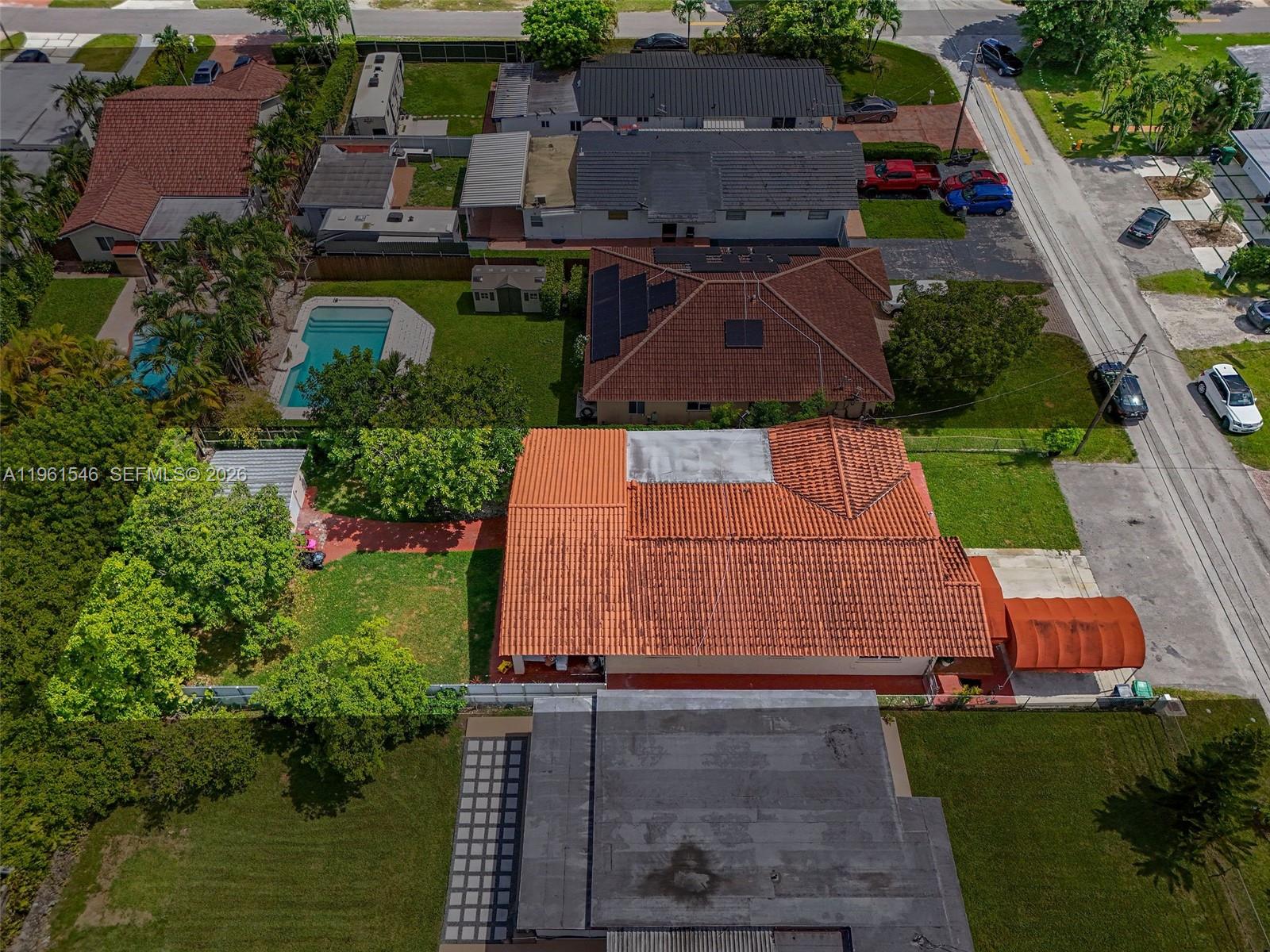 An aerial view shows several residential houses with tiled roofs, swimming pools, and paved driveways — 2821 SW 65th Ave, Miami FL 33155, MIAMI, FL