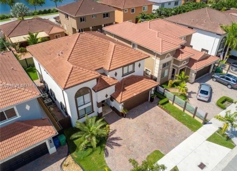 An aerial view of a two-story suburban house with a tiled roof and paved driveway — 16588 SW 44 Street, Kendall FL 33185, KENDALL, FL