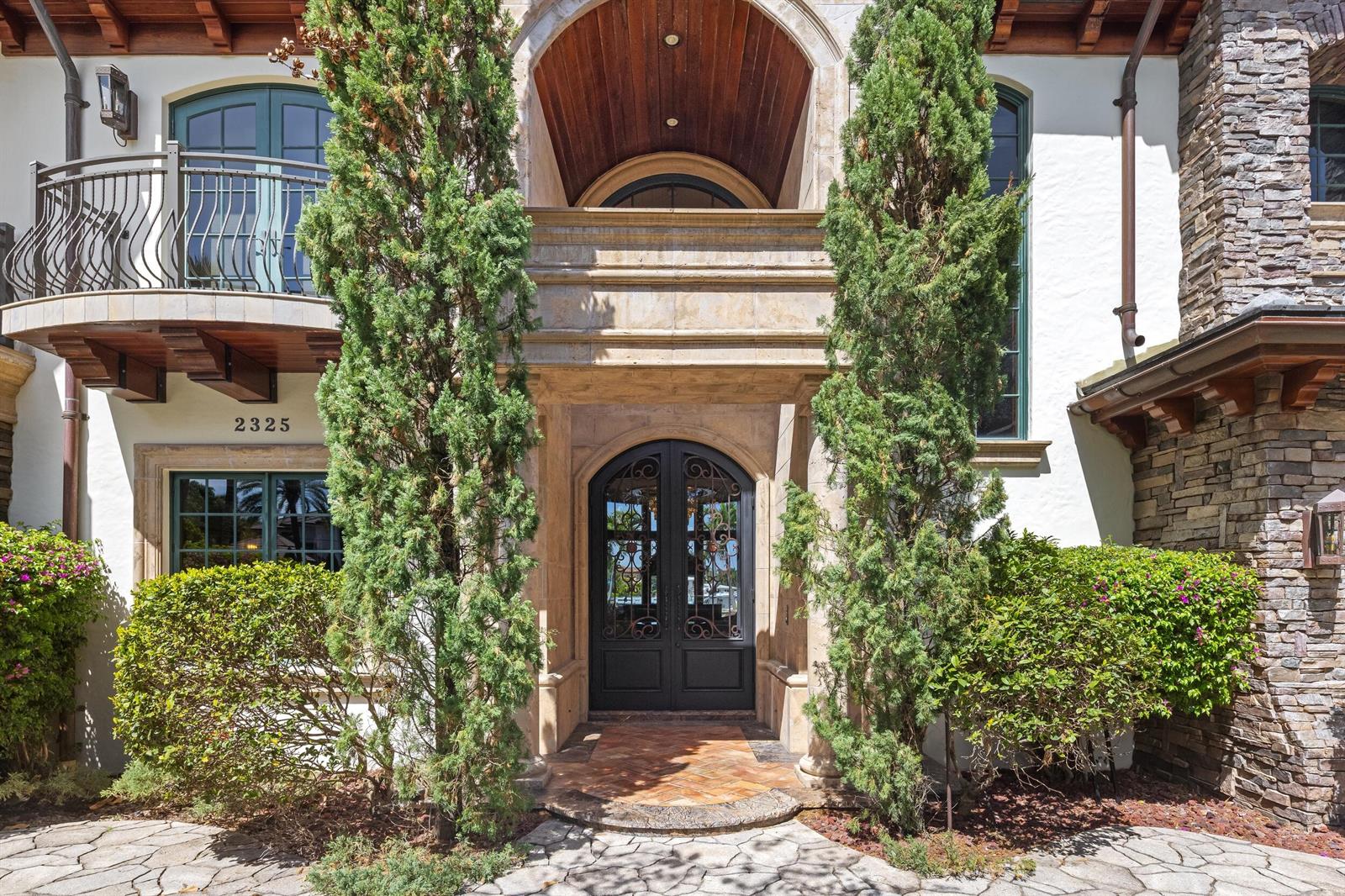 A game room features a pool table, a bar with stools, and open doors to a marina — 2325 NE 27th Street, Lighthouse Point FL 33064, LIGHTHOUSE POINT, FL