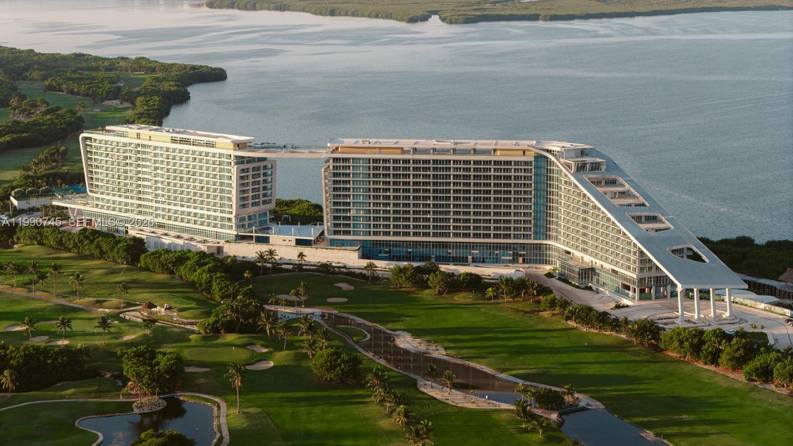 An aerial view of a large, modern hotel complex situated next to a golf course — Zona Hotelera Cancun # 1031, TX 77500, TX