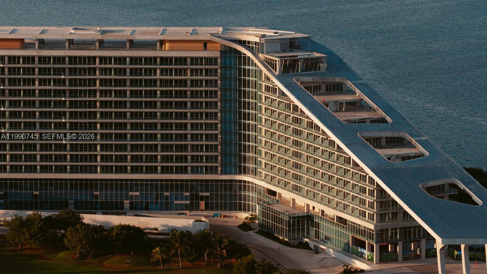 An aerial view of a large, modern, partially completed building with a sloped roofline — Zona Hotelera Cancun # 1031, TX 77500, TX
