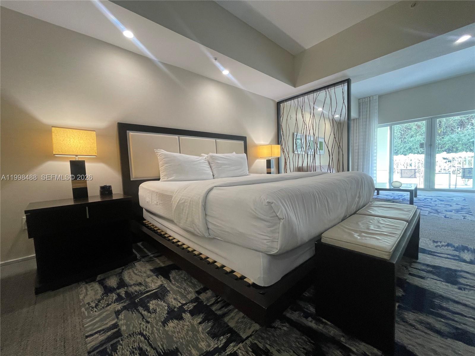 A bedroom features a platform bed, a decorative room divider, and a patterned area rug — 5300 NW 87th Ave # 1103, Doral FL 33178, DORAL, FL