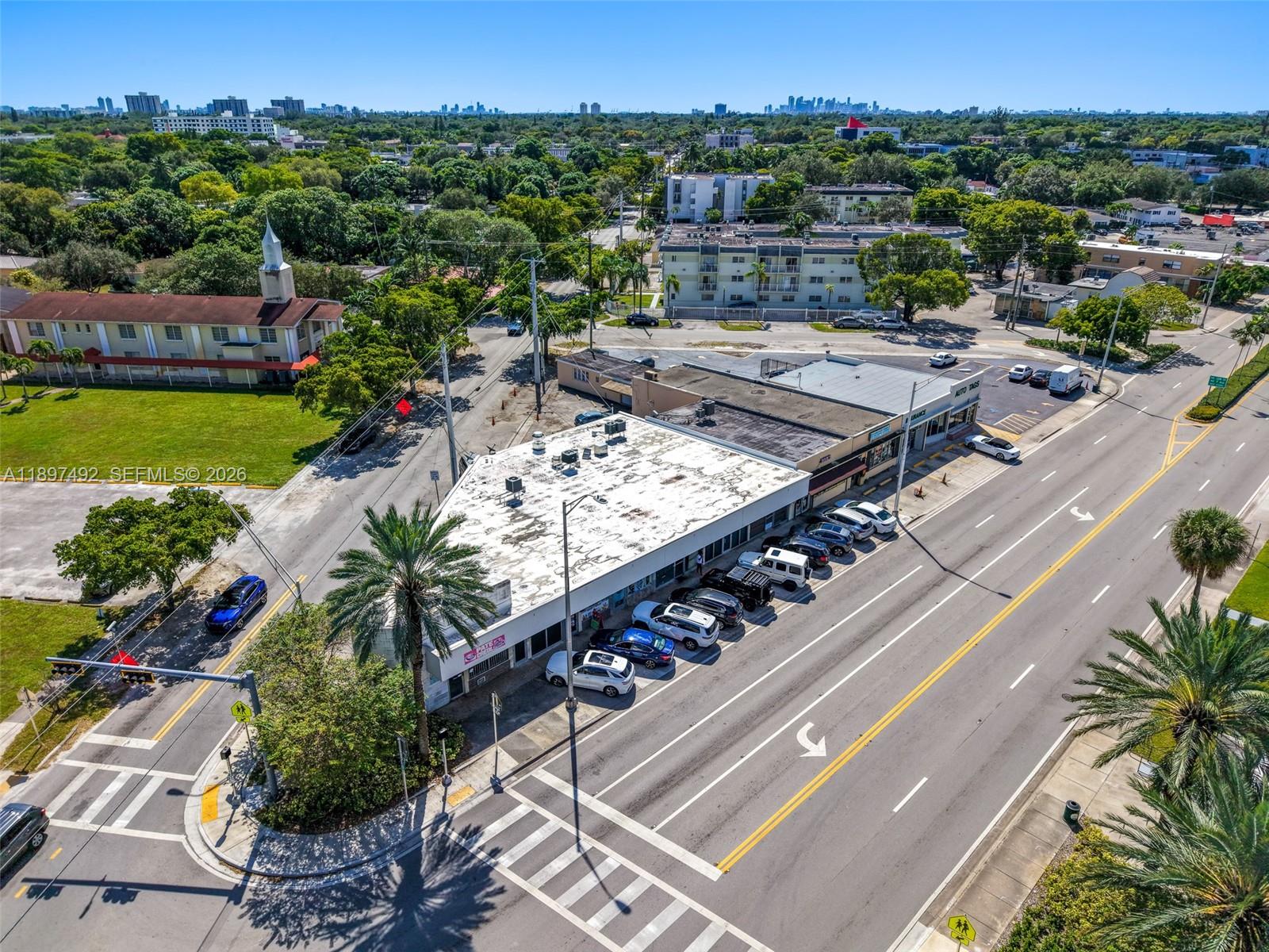 An aerial view shows a commercial building with a parking lot along a road — 12985 W Dixie Hwy, North Miami FL 33161, NORTH MIAMI, FL