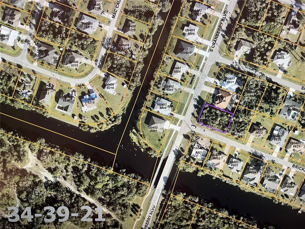 This is a property tax map showing residential lots, streets, and a canal — LOT 25 BRICKELL DRIVE, NORTH PORT, FL