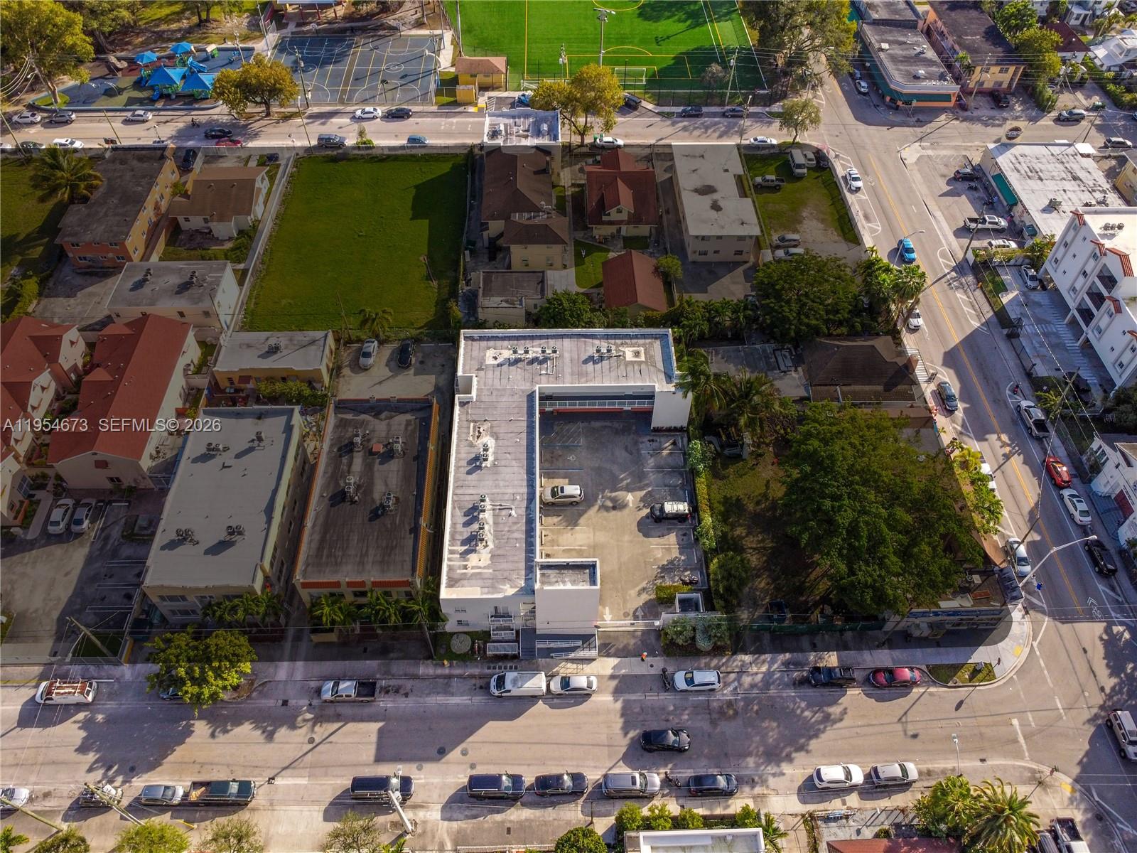 An aerial view shows a commercial building with a parking lot and surrounding urban streets — 750 SW 2nd St, Miami FL 33130, MIAMI, FL