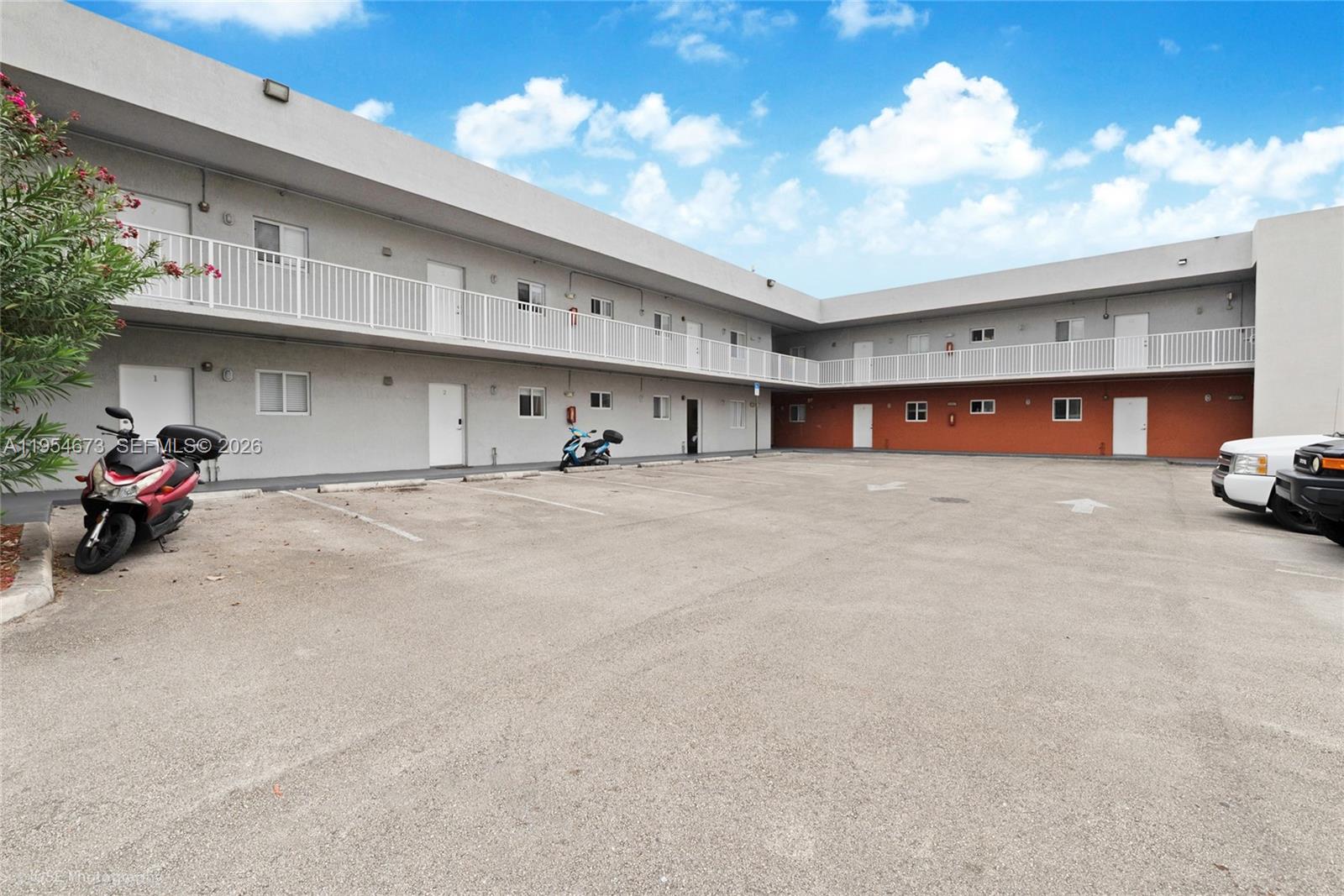 A two-story apartment building with a parking lot and exterior walkways — 750 SW 2nd St, Miami FL 33130, MIAMI, FL