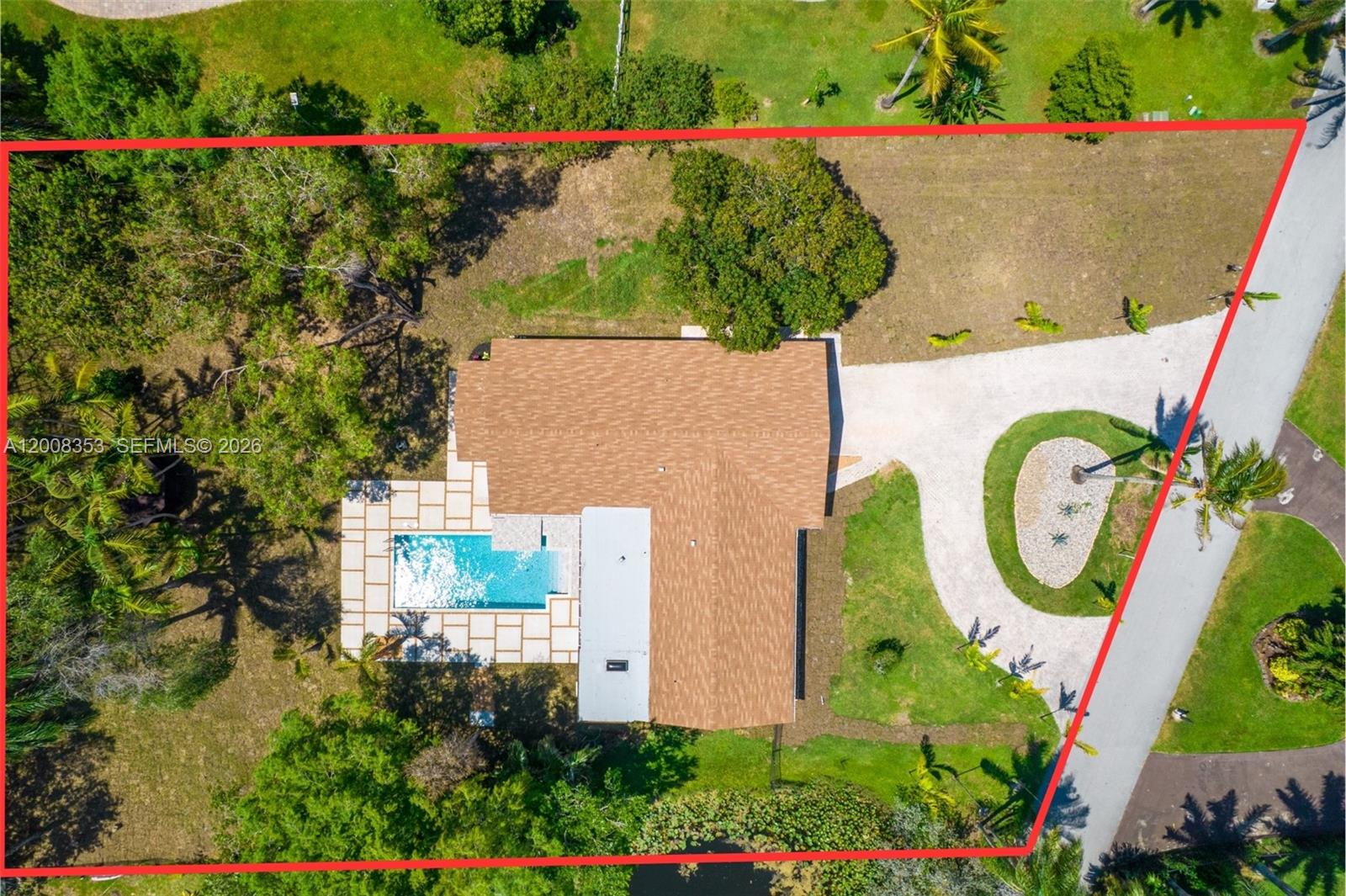 An aerial view shows a house with a pool and a circular driveway on a lot — 4700 SW 110th Ave, Davie FL 33328, DAVIE, FL