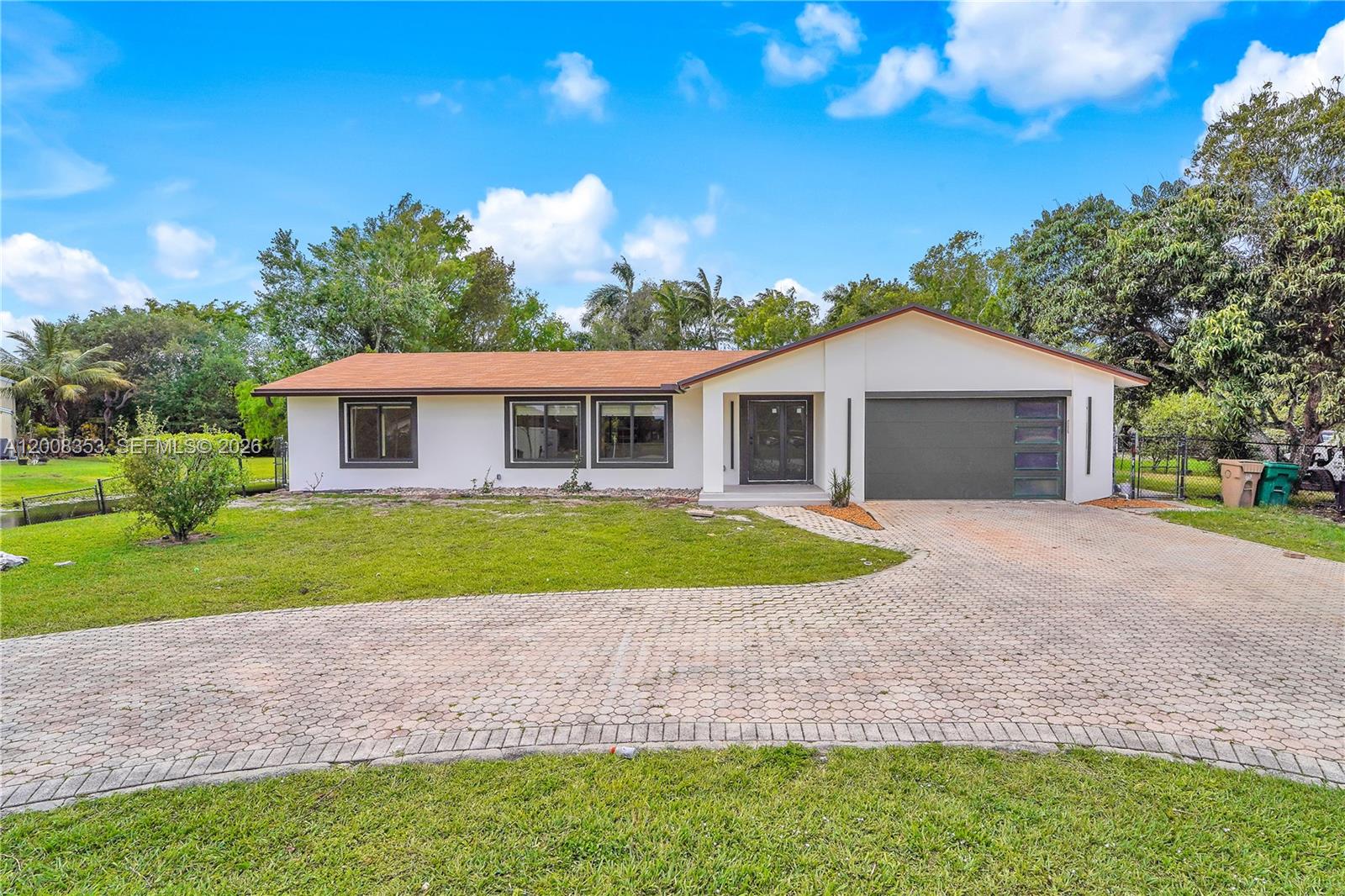A single-story house with a white exterior, brown roof, and a paved circular driveway — 4700 SW 110th Ave, Davie FL 33328, DAVIE, FL