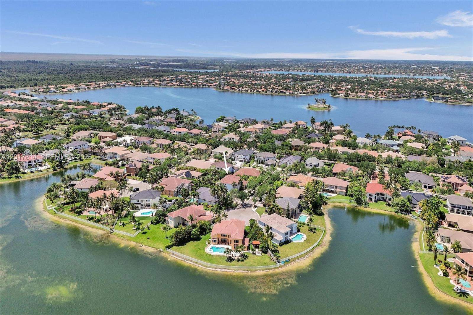 An aerial view shows a residential neighborhood with houses surrounding a large lake — 4142 SW 188th Ave, Miramar FL 33029, MIRAMAR, FL