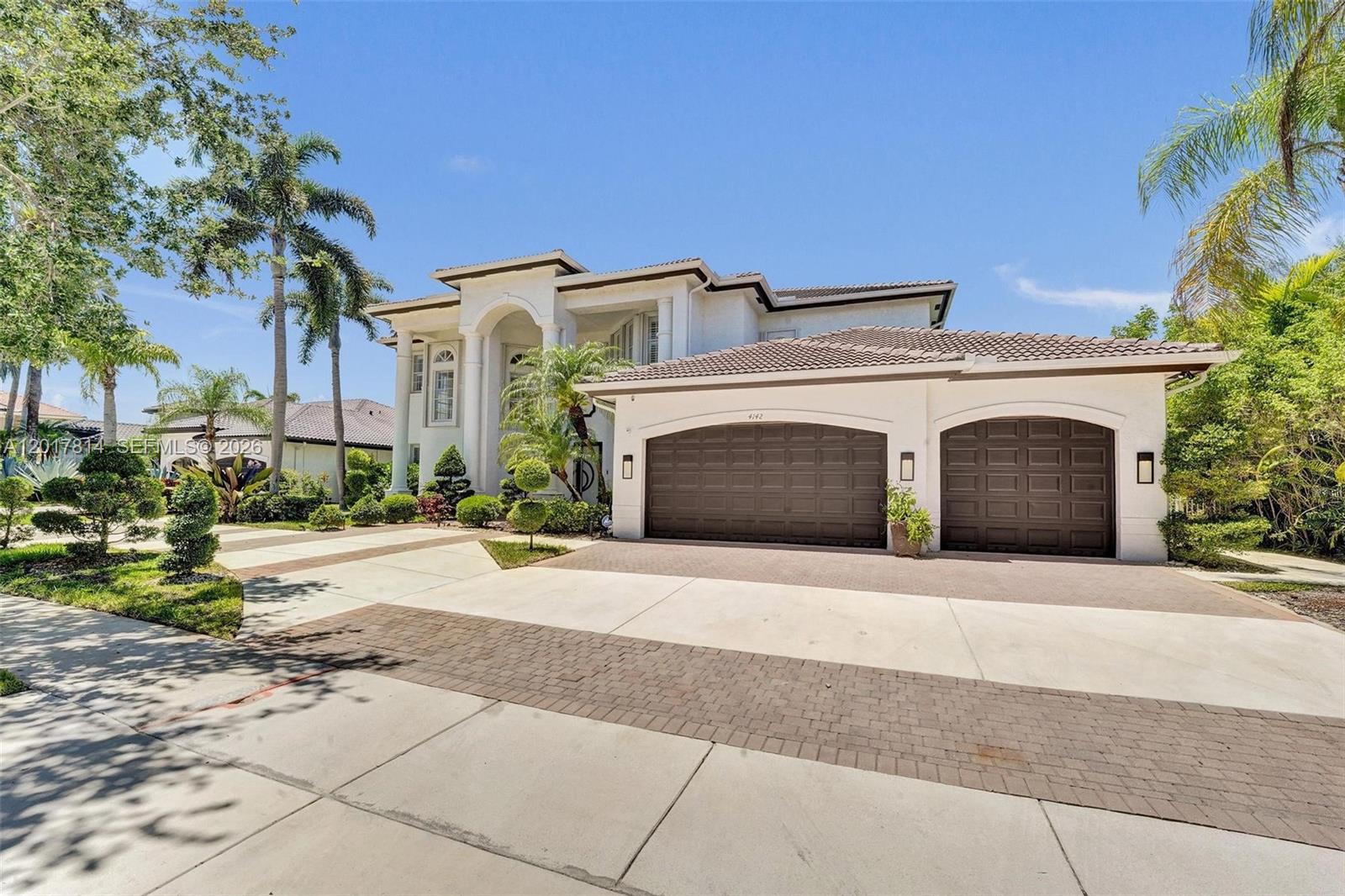 A two-story house with a white exterior, a three-car garage, and palm trees — 4142 SW 188th Ave, Miramar FL 33029, MIRAMAR, FL