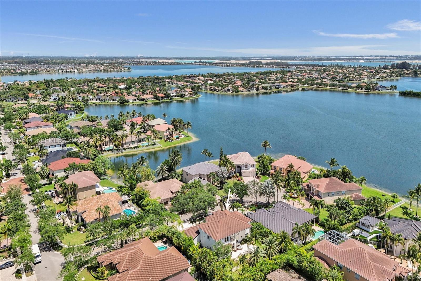 An aerial view shows a residential neighborhood with houses surrounding a large lake — 4142 SW 188th Ave, Miramar FL 33029, MIRAMAR, FL