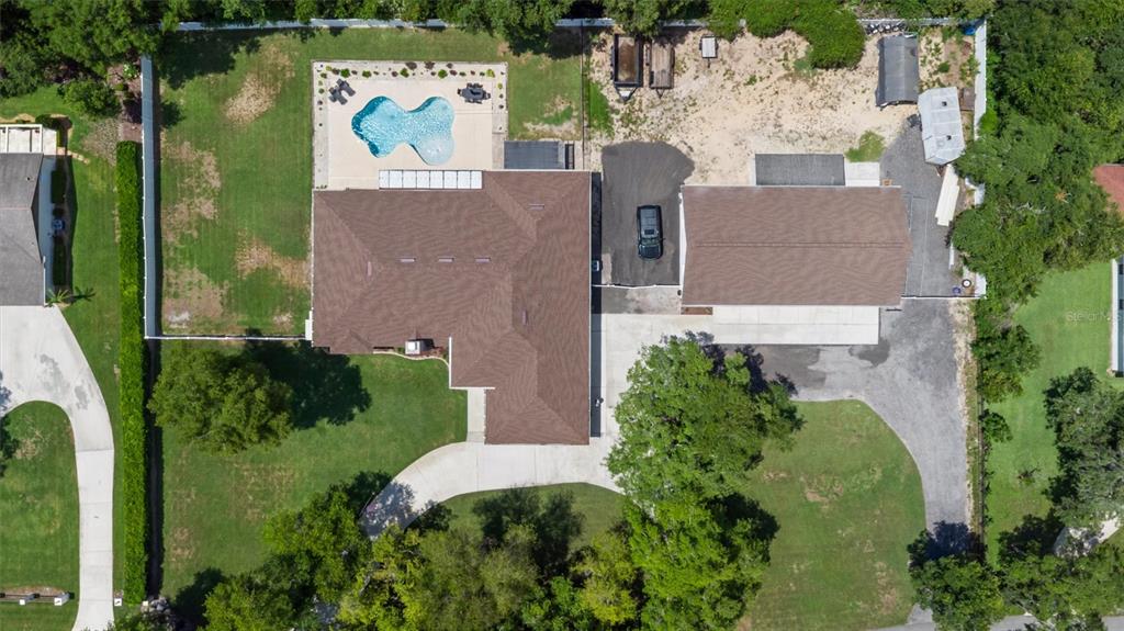 An aerial view shows a house with a pool, a detached garage, and a driveway — 713 ERNEST DRIVE, PORT ORANGE, FL