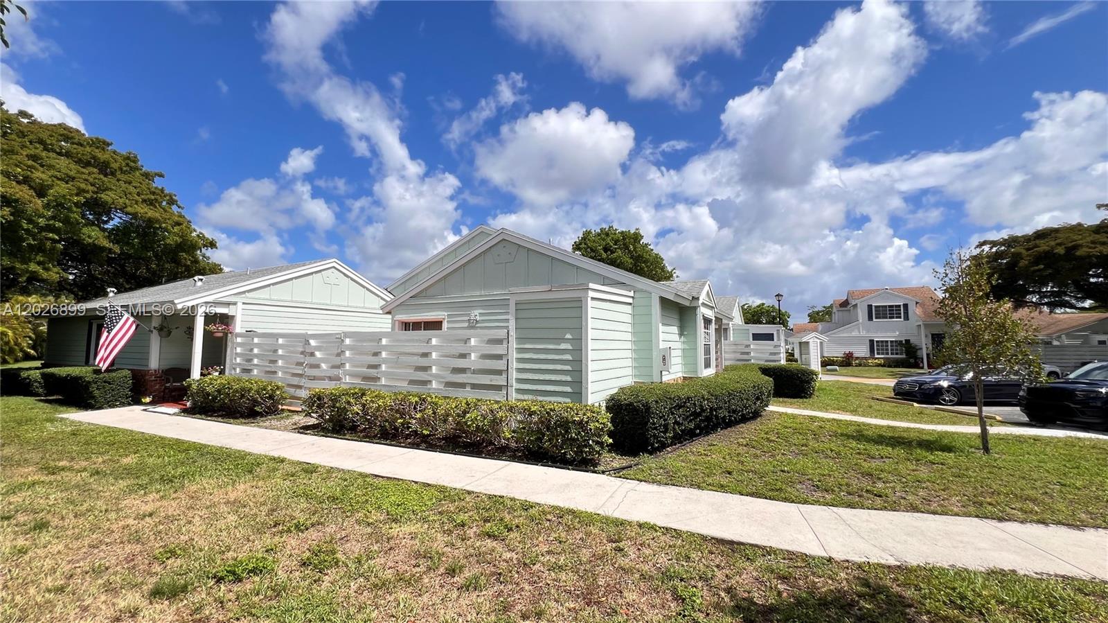 A light green single-story house with a white fence and a sidewalk in front — 13775 SW 149th Cir Ln # 86, Miami FL 33186, MIAMI, FL